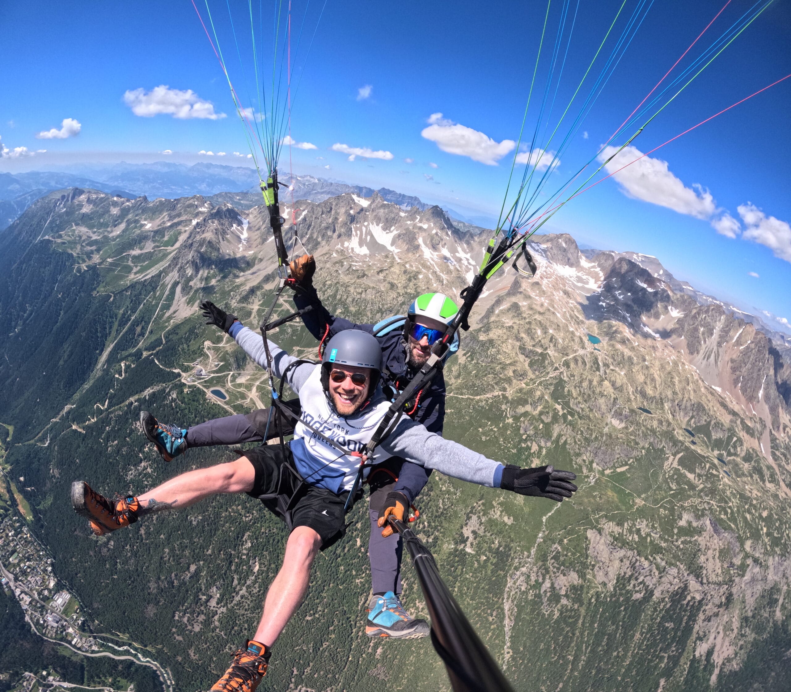 happy-passenger-FLYddiction High-altitude paragliding with smiling passenger and pilot